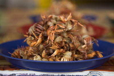 Close-up of crabs in plate on table