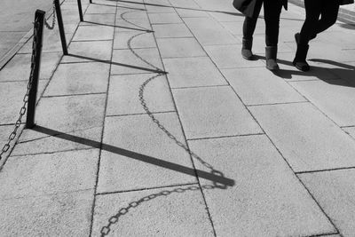 Low section of people walking on zebra crossing