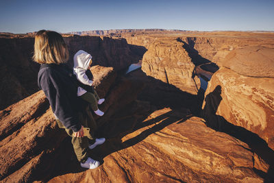 Full length of woman on rock formation against sky