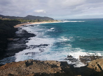 Scenic view of sea against cloudy sky