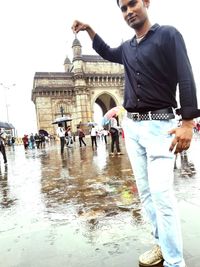 People standing on wet road during rainy season