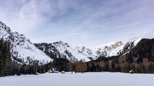 Scenic view of snow covered mountains against sky