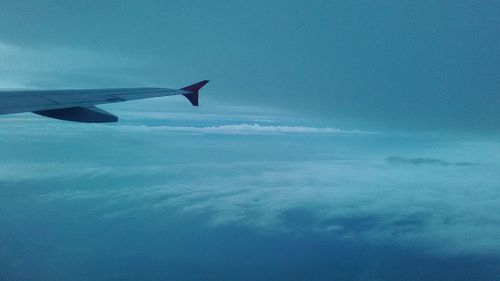 Airplane wing against sky