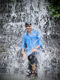 Portrait of man splashing water