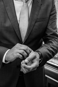 Midsection of businessman wearing watch