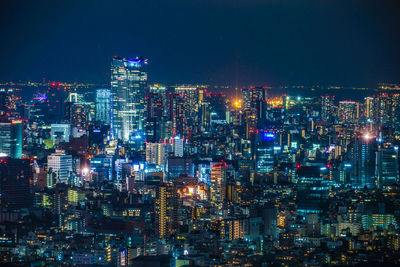 High angle view of illuminated city buildings at night