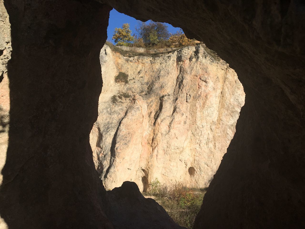 LOW ANGLE VIEW OF ROCK FORMATIONS AT CAVE