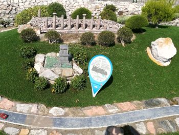 High angle view of information sign on grass