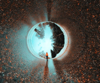 Reflection of people on road in tunnel