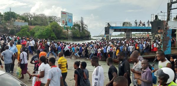 Group of people in city against sky