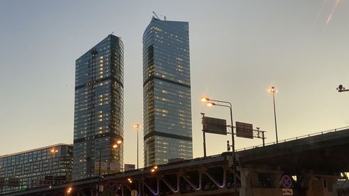 Low angle view of illuminated buildings against sky at dusk