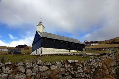 View of old building against cloudy sky