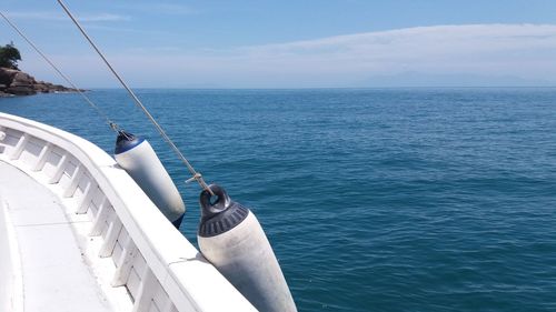 Boat sailing in sea against sky