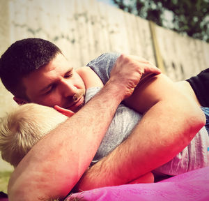 Close-up of boy and father hugging outdoors