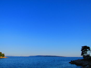 Scenic view of sea against clear blue sky