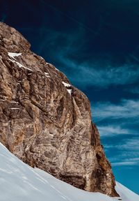 Rock formations by mountain against sky