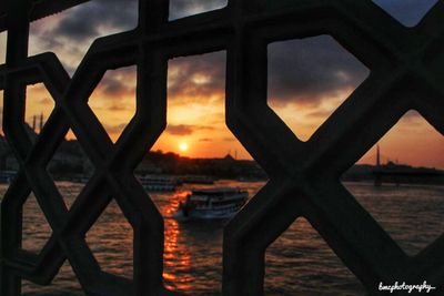 Close-up of silhouette built structure against sunset sky