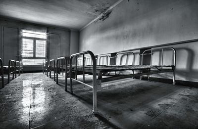 Row of metallic beds in abandoned building