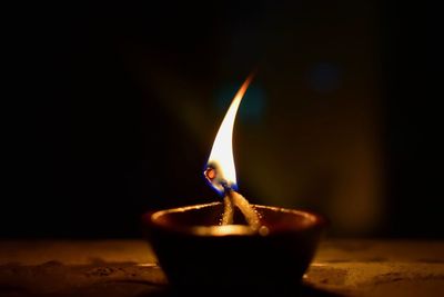 Close-up of illuminated oil lamp