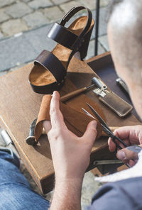 Close-up of shoemaker making sandal at workshop