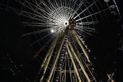 Low angle view of illuminated ferris wheel at night