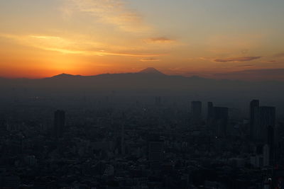 Cityscape against sky during sunset