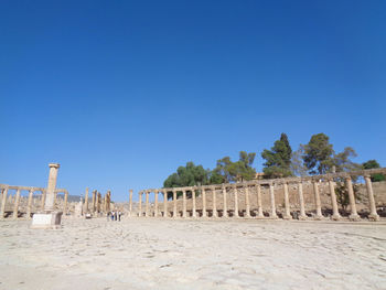 Built structure on beach against clear blue sky