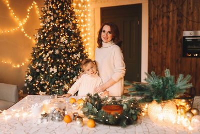 Portrait of woman holding christmas tree