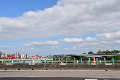 View of amusement park against cloudy sky