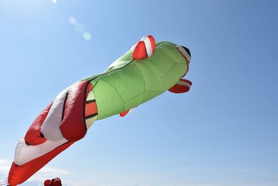 Low angle view of multi colored umbrella against clear blue sky