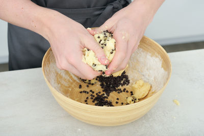 Cropped hand of person preparing food