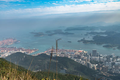 High angle view of buildings by sea against sky