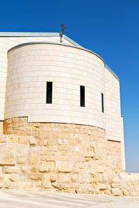 Low angle view of building against clear blue sky