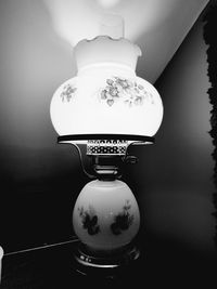 Close-up of illuminated lamp on table