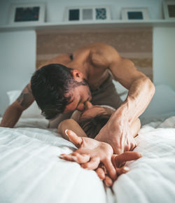 Young man lying on bed at home