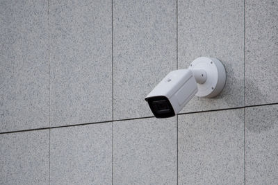 Surveillance camera on wall, outdoors. video observation at modern house