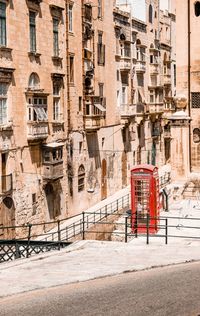 Red phone booth in city