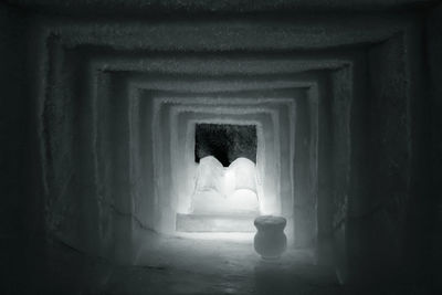 Rear view of woman standing in tunnel