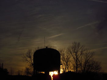 Low angle view of silhouette trees against sky at sunset