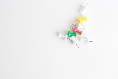 Close-up of colored pencils over white background