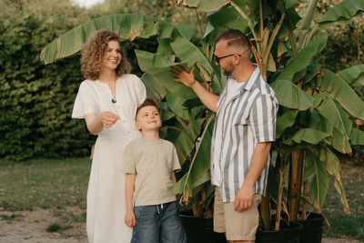 Portrait of couple standing against plants