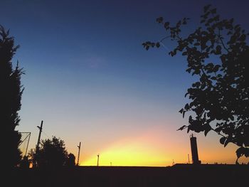 Low angle view of silhouette trees against sky