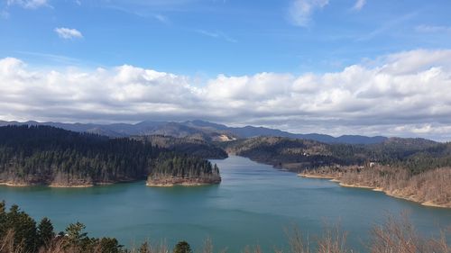 Scenic view of land and mountains against sky