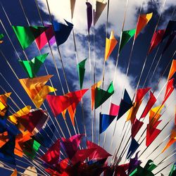 Close-up of multi colored umbrellas against sky