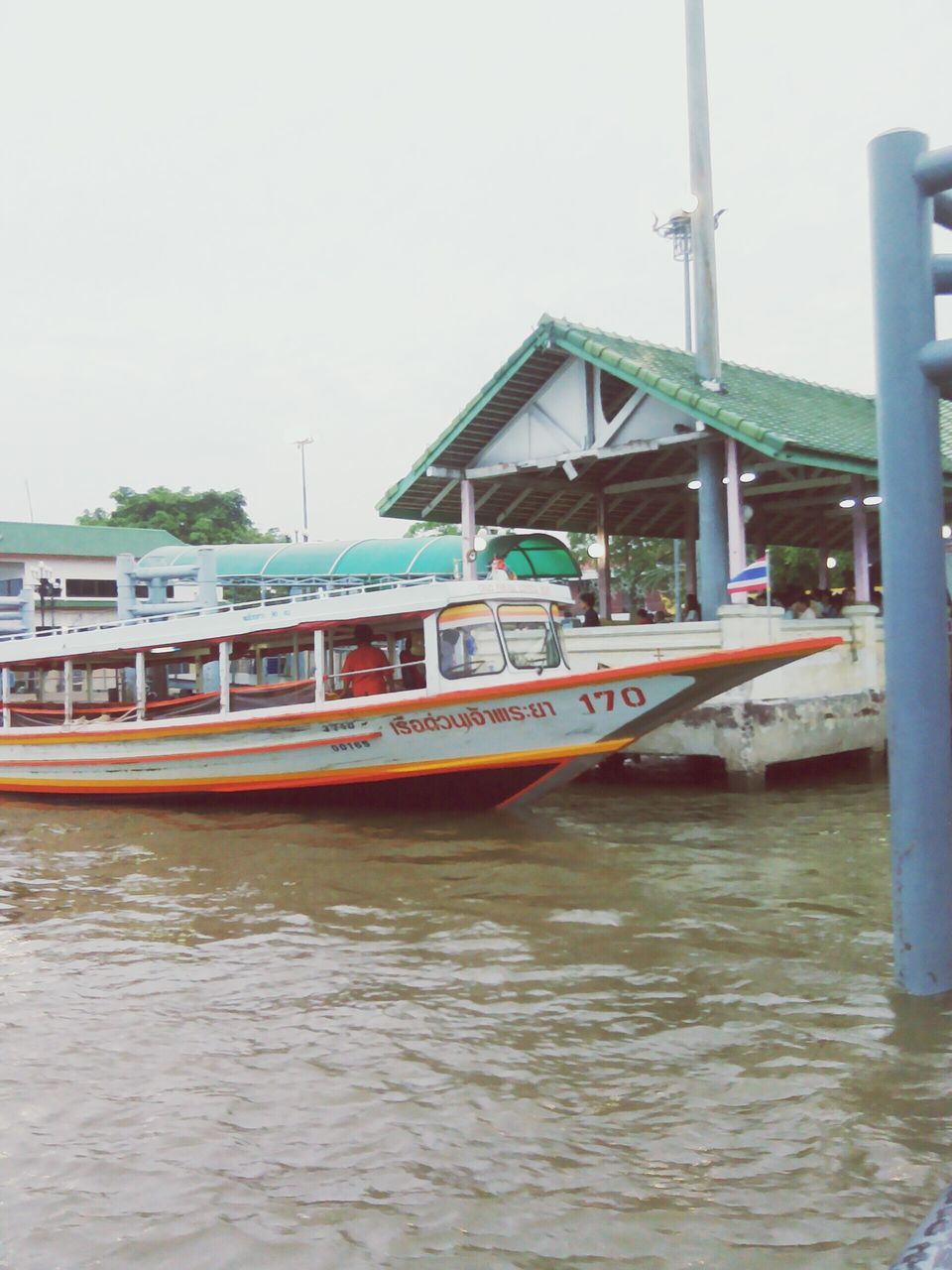 water, nautical vessel, transportation, waterfront, mode of transport, built structure, boat, architecture, clear sky, building exterior, moored, river, rippled, travel, day, sea, reflection, sky, copy space, outdoors