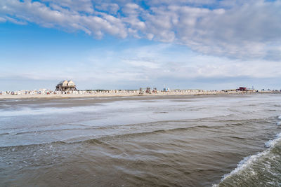 Scenic view of beach against sky in city