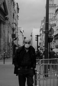 Portrait of man standing on street in city