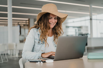 Young woman using laptop at table