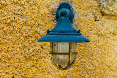 Close-up of lamp against wall