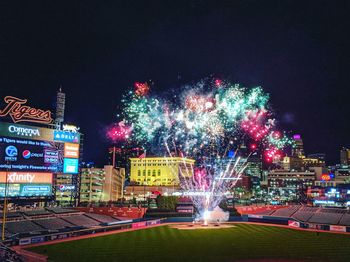 Firework display in city at night